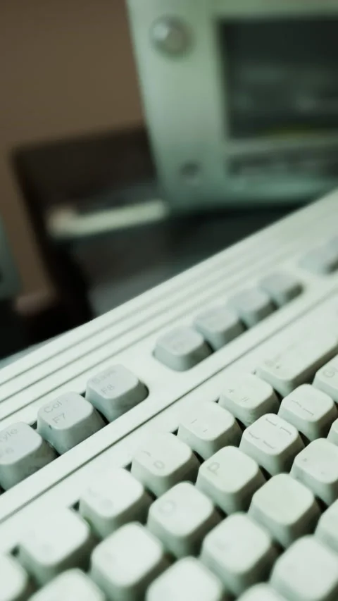 Old computer keyboard captures nostalgia in a vintage workspace during daytime Stock Footage 334244736