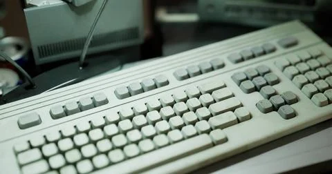 Old computer keyboard resting on a cluttered desk with various items Stock Illustration