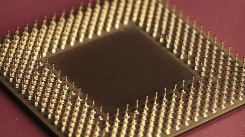 The Old Computer Processor CPU with Gold Plated Contacts Spins on Red Background Stock Footage 145917166