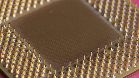 The Old Computer Processor CPU with Gold Plated Contacts Spins on Red Background Stock Footage 145917444