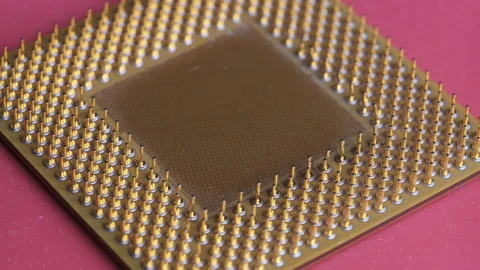 The Old Computer Processor CPU with Gold Plated Contacts Spins on Red Background Stock Footage 146014705