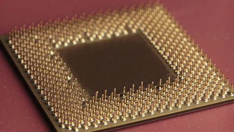 The Old Computer Processor CPU with Gold Plated Contacts Spins on Red Background Stock Footage 146097055