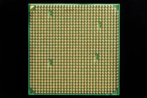 Old computer processor with gilt legs isolated on black background Stock Photos