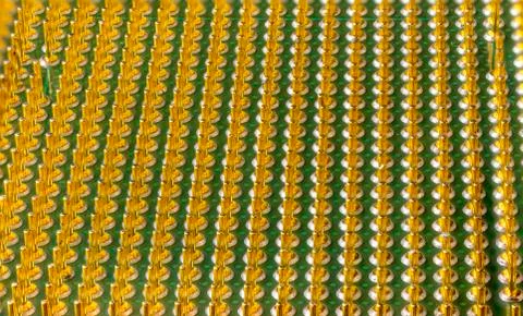 Old computer processor with gilt legs, super macro photo Foto stock