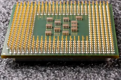 Old computer processor with gold-plated legs, microcircuits on it, on a black 写真素材