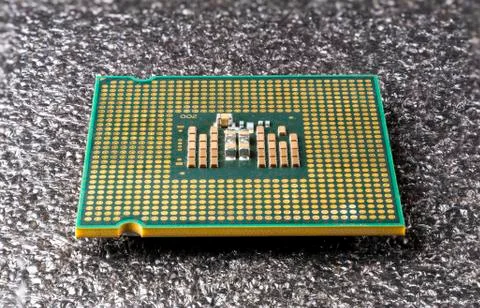 Old computer processor lies upside down on a black soft pad 写真素材