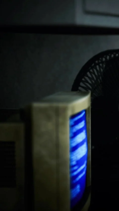 Old computer screen shows blue error message in a dimly lit room Stock Footage 334212593