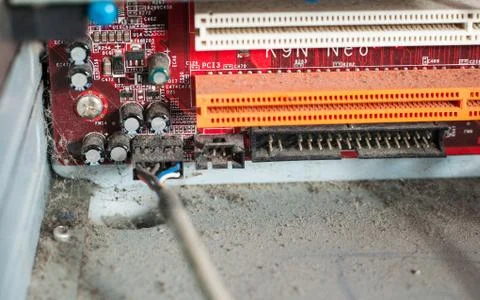 Old computer system unit with dust and spiderweb inside. Stock Photos