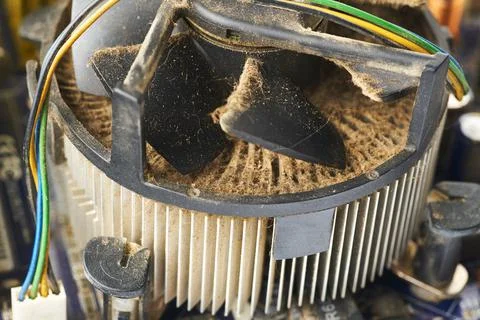 Old computer system unit with spiderweb and dust inside. Stock Photos