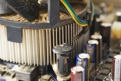 Old computer system unit with spiderweb and dust inside. Stock Photos