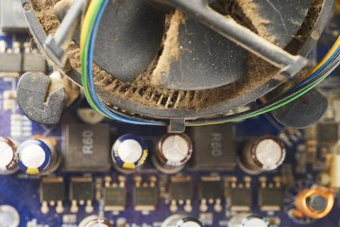 Old computer system unit with spiderweb and dust inside. Stock Photos