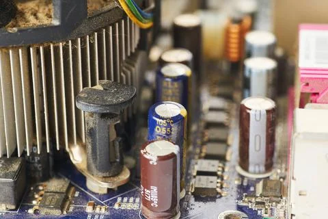 Old computer system unit with spiderweb and dust inside. Stock Photos