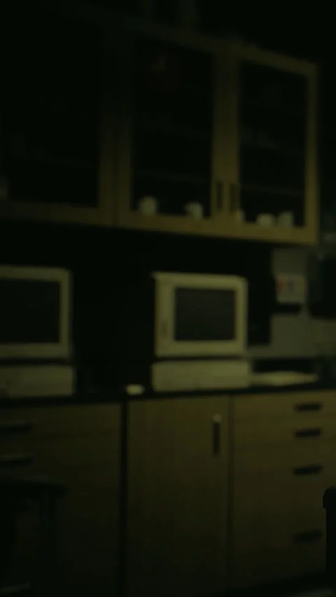 Old computers and cabinets in a dimly lit room showing a tech workspace Stock Footage 332228573