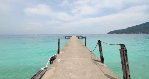Old concrete pier extending into the turquoise waters of Perhentian Islands Stock Footage 314636668