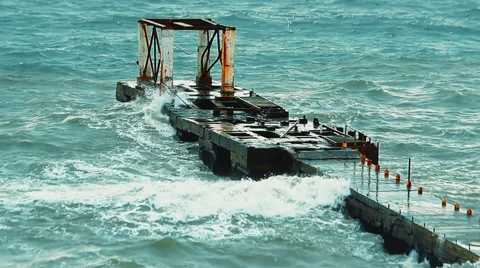 Old concrete structure in the sea breaking waves during a heavy storm Stock Footage 61073701