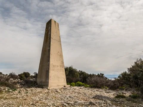 Old concrete triangular pillar on the island of Cres Stock Photos