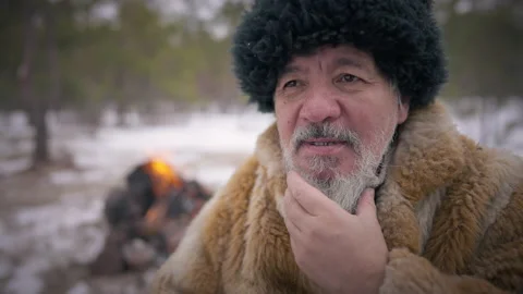 Old confident indigenous man stroking grey beard looking away smiling. Portrait Stock Footage 163760319