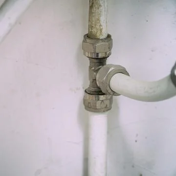 Old connection fitting tee on plastic pipes Stock-Fotos