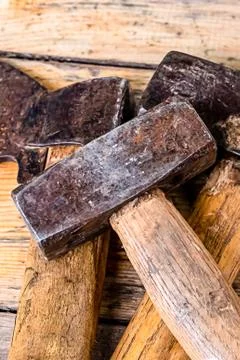 The old construction tool the axe the hammer heavy lies on the wooden machine Stock Photos