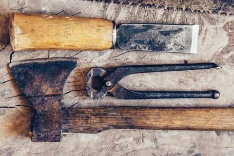 Old construction tools on a wooden workbench flat lay background. Carpenter t Stock Photos