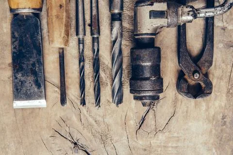 Old construction tools on a wooden workbench flat lay background. Carpenter.. Stock Photos