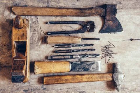 Old construction tools on a wooden workbench flat lay background. Carpenter.. Stock Photos