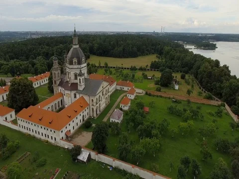 Old convent and church on lake shore establishing shot aerial Stock Footage