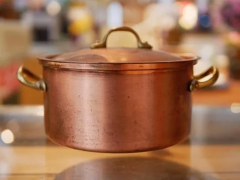 Old copper cooking pot placed on glass shelf Stock Photos
