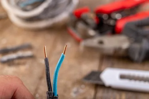 Old copper electric wire and combination pliers. Electrical installation repa Stock Photos