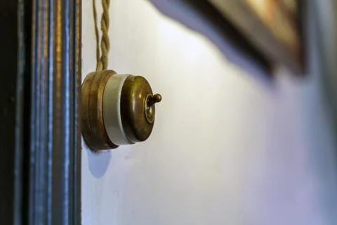 Old copper electricity switch with ceramic insulation ring Stock Photos