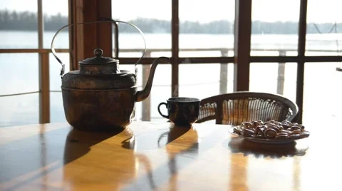 Old copper kettle ,teacup and basket with bagels are on big wooden table. Stock Footage 46184853