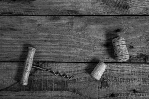 Old corkscrew and wine corks on a wooden table Stock Photos