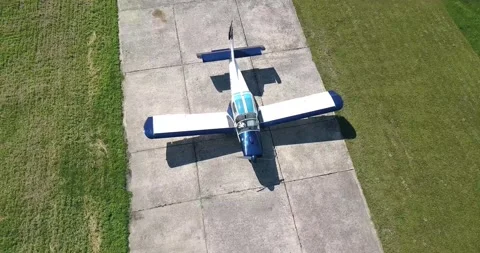 An old corn plane is standing in a field on the runway, the camera turns slowly Video stock 138035173