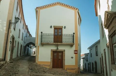 Old corner house with whitewashed wall in an alley of Marvao Stock Photos