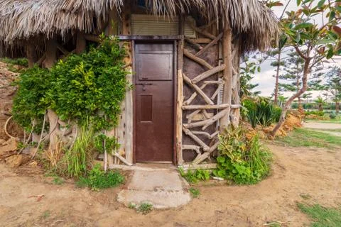 Old cottage made of tree trunks with closed wooden brown grunge door Stock Photos