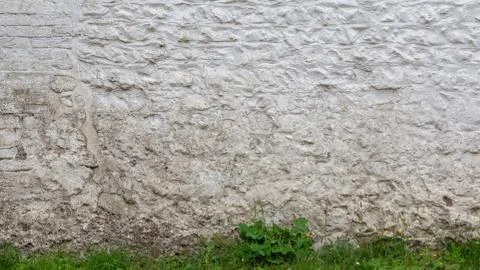 Old Cottage Wall Background with Grass Stock Photos