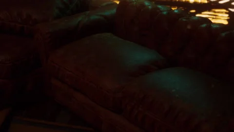 Old couches in an empty room with light shining through the window Stock Footage 345005093