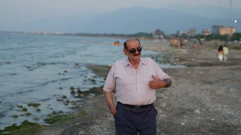 Old couple on the beach Stock Footage 313822670