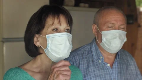 Old couple behind window take off masks Video stock 131739561