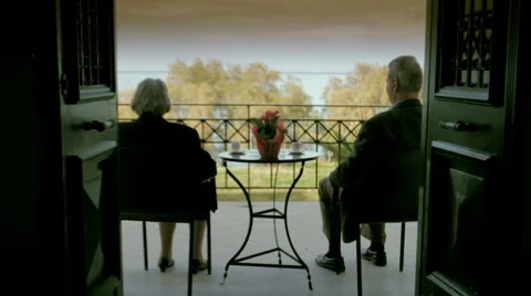 Old couple drinking coffee on veranda Stock Footage 2375120