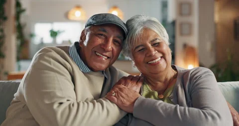 Old couple, face and hug in home for commitment, care and love for comfort in 動画素材 283160735