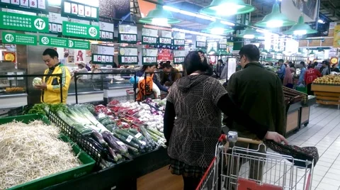 Old couple go shopping in the vegetable area in a supermarket in Chengdu,China Stock Footage 42823976