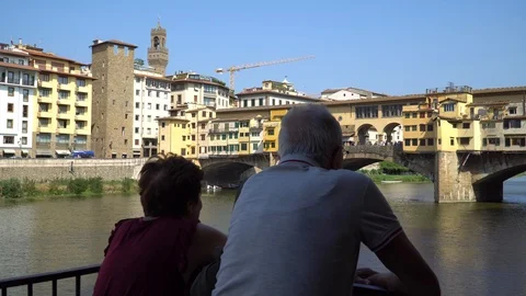 An old couple look at Ponte Vecchio Bridge. Florence, Italy. 4K. Stock Footage 94967600