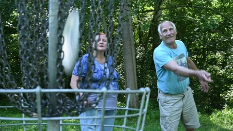 Old couple playing disc golf 動画素材 139215366