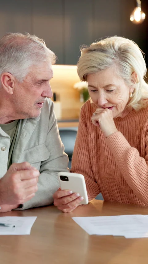 Old couple, reading and document in home with phone, research and letter for Stock Footage 337493264