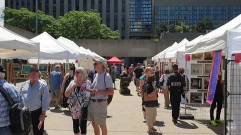 Old couple talking and shopping at toronto art fair Stock Footage 280869904