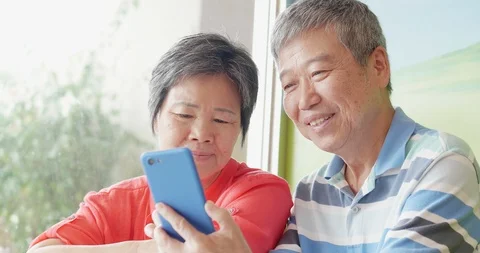 Old couple use smartphone Stock Footage 115782389
