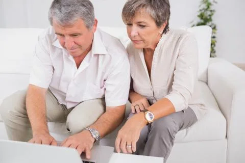 Old couple using a laptop Stock Photos