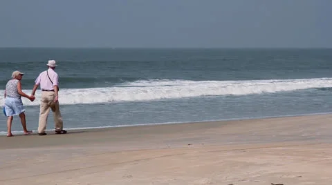 Old couple walk on the beach Stock Footage 26268389