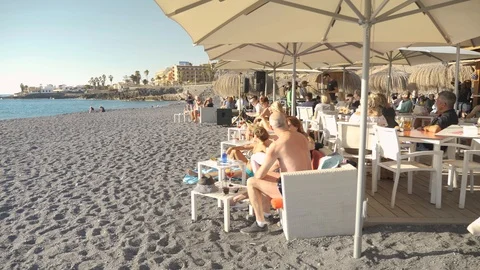 Old Couple Walking To Bar Restaurant Playa De La Caleta Tenerife Spain Slow Stock Footage 104395725